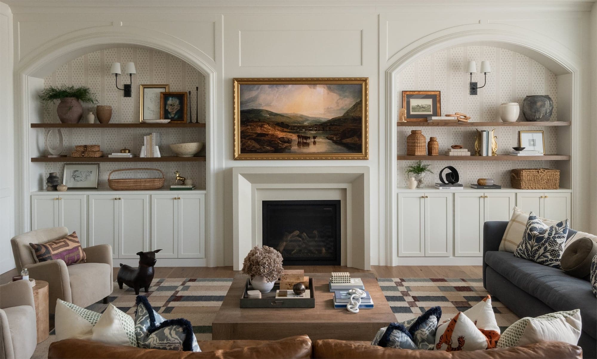 Cast stone fireplace surround photographed in a styled residence